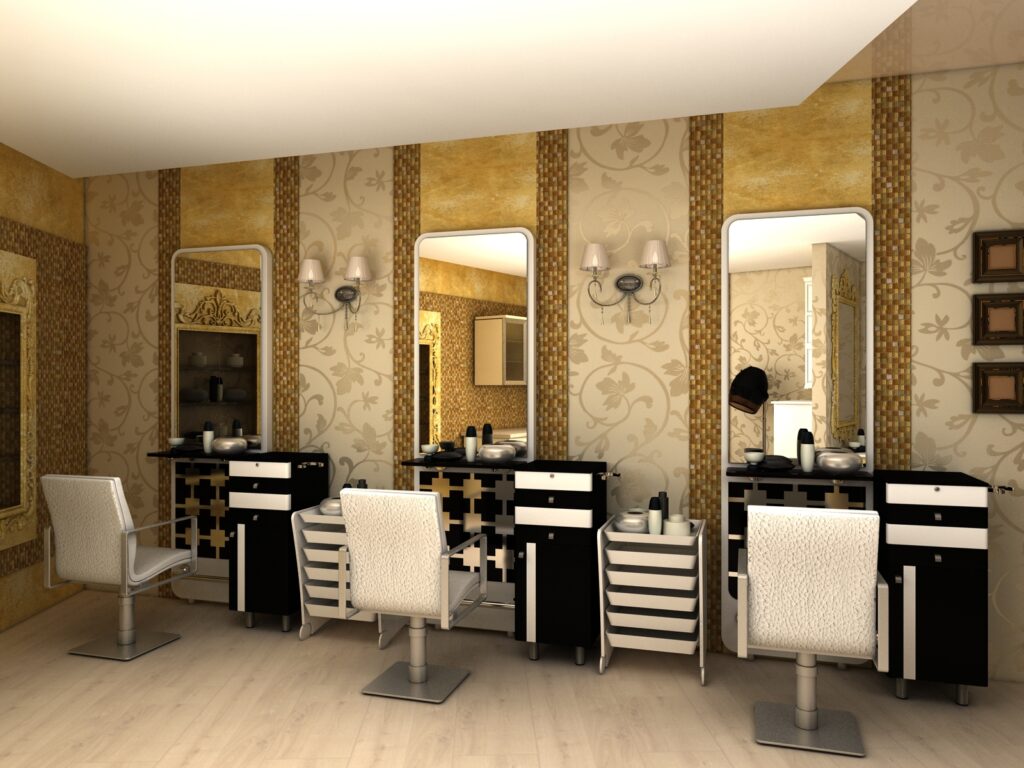 gold textured walls with vintage style wallpaper. Black & white color theme with the chairs & tables & a chandelier hanging. routine style shop. 